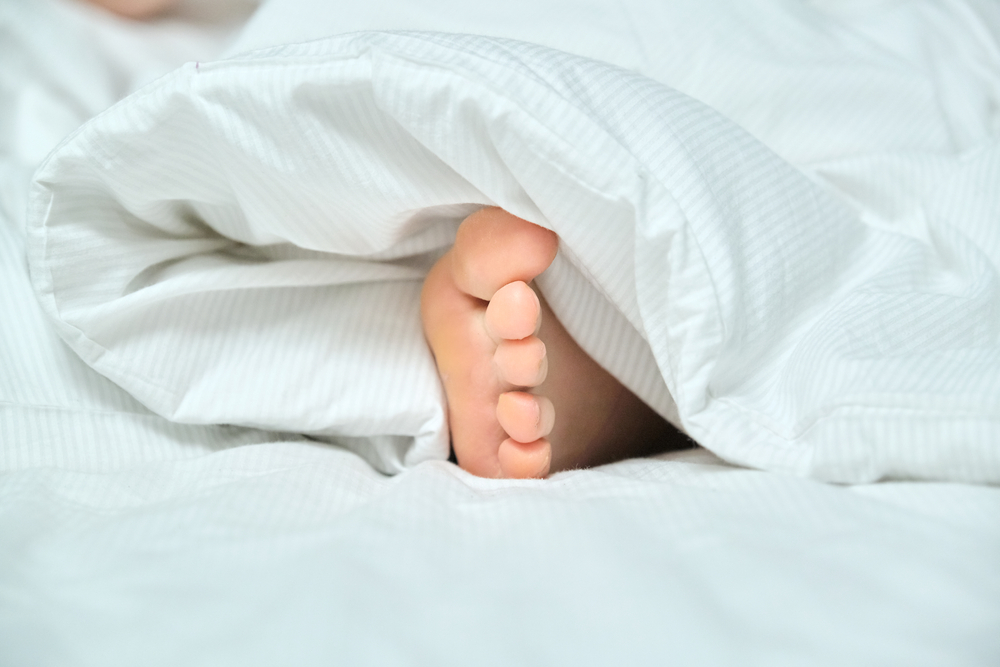 Why Sleeping With One Foot Out May Improve Your Sleep